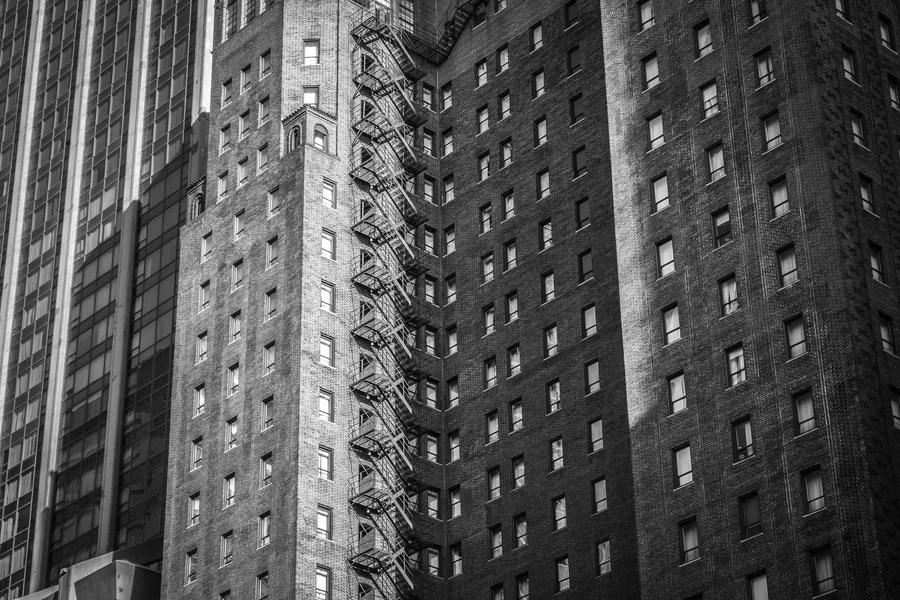 High-rise housing blocks seen from street level in black and white