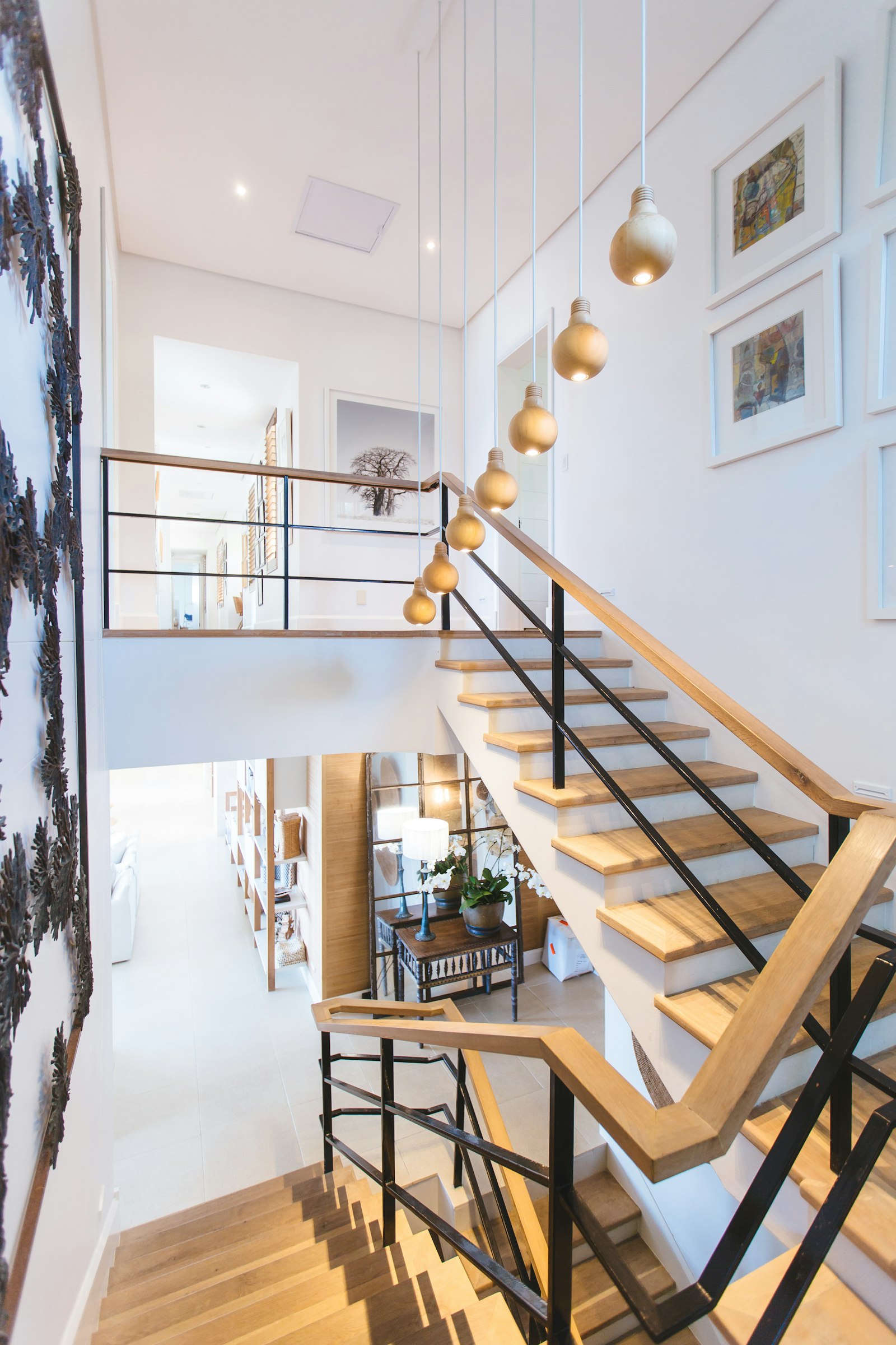Timber stair and mezzanine in a converted interior, lit by pendant lights