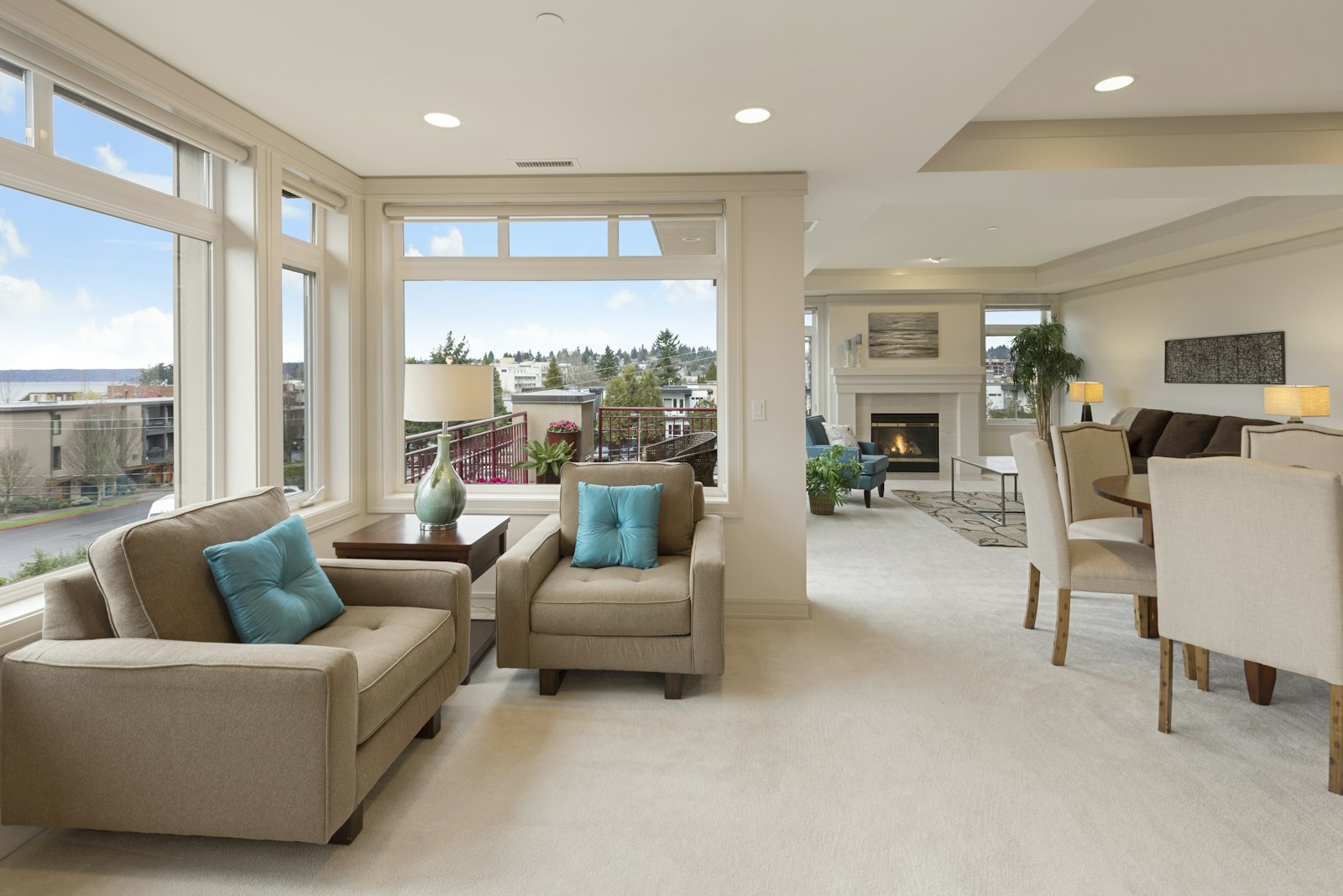 A sunlit living room with a linen sofa, timber floors, and a pendant lamp
